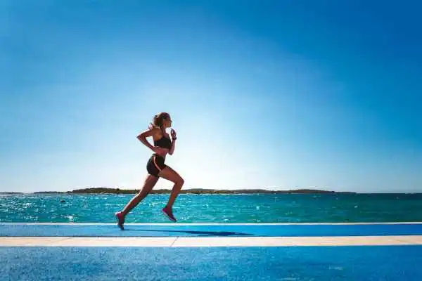 Woman running showing strong leg muscle Herne